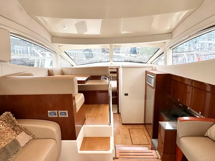  Yacht Photos Pics Interior of 2012 Sea Ray 450 Sedan Bridge yacht with luxurious seating and wood finishes.