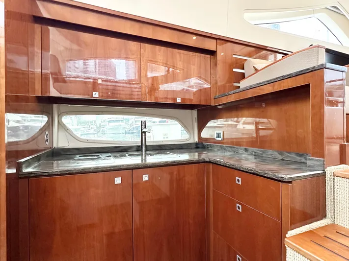 Yacht Photos Pics Luxurious kitchen interior of 2012 Sea Ray 450 Sedan Bridge yacht with wooden cabinetry.