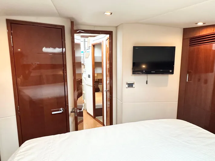  Yacht Photos Pics Luxurious interior of 2012 Sea Ray 450 Sedan Bridge yacht with TV and wooden finishes.