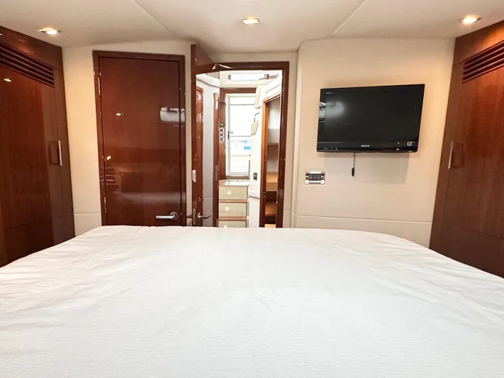  Yacht Photos Pics Luxurious cabin interior of 2012 Sea Ray 450 Sedan Bridge with TV and wood finishes.