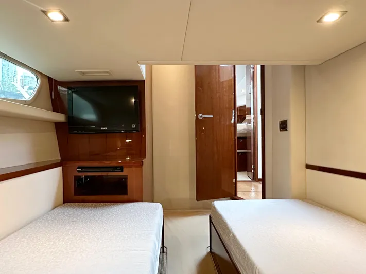  Yacht Photos Pics Interior of 2012 Sea Ray 450 Sedan Bridge with twin beds and TV.