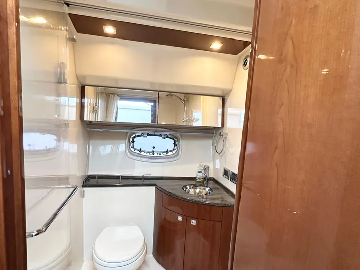  Yacht Photos Pics Luxurious bathroom in 2012 Sea Ray 450 Sedan Bridge yacht with modern fixtures and wood accents.