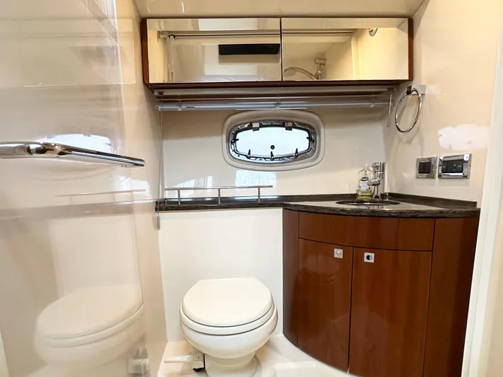  Yacht Photos Pics Luxurious bathroom in 2012 Sea Ray 450 Sedan Bridge yacht with modern fixtures and wood cabinetry.