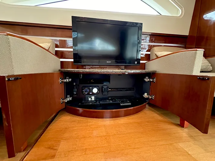  Yacht Photos Pics 2012 Sea Ray 450 Sedan Bridge interior with TV and open cabinet storage.