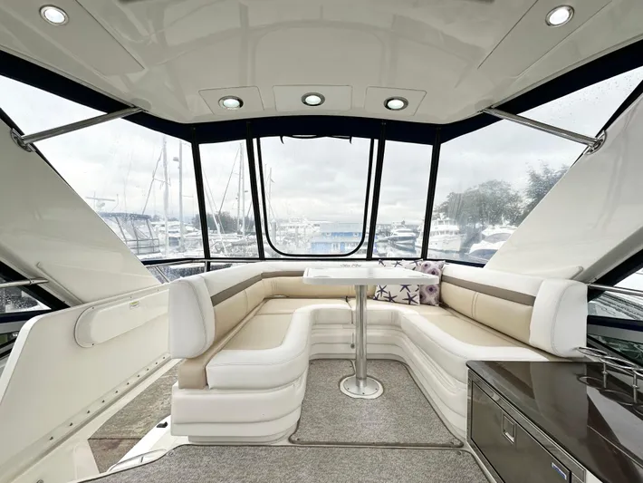  Yacht Photos Pics Luxurious interior of 2012 Sea Ray 450 Sedan Bridge yacht with elegant seating and panoramic windows.