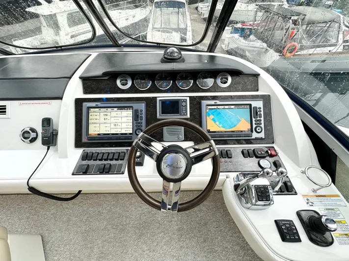  Yacht Photos Pics Helm of 2012 Sea Ray 450 Sedan Bridge with navigation screens and controls.