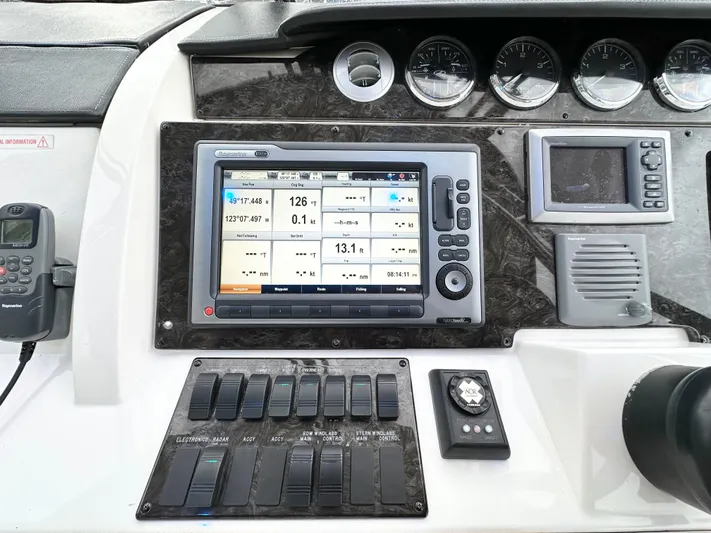  Yacht Photos Pics Control panel of 2012 Sea Ray 450 Sedan Bridge with navigation display and switches.