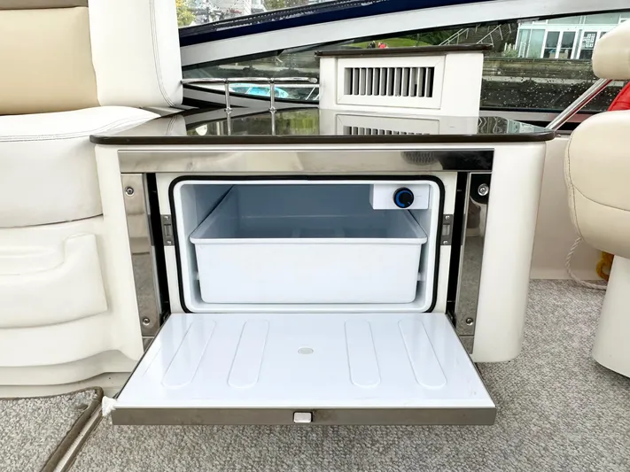  Yacht Photos Pics Open mini fridge on 2012 Sea Ray 450 Sedan Bridge yacht, showcasing interior storage.