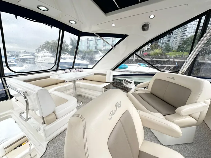  Yacht Photos Pics Luxurious interior of 2012 Sea Ray 450 Sedan Bridge yacht with plush seating and panoramic windows.