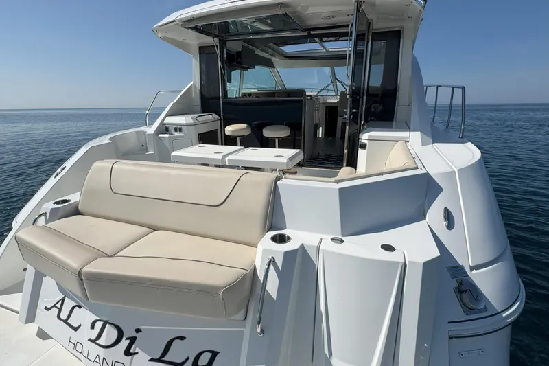  Yacht Photos Pics 2017 Cruisers Yachts 45 Cantius with spacious deck and seating on calm water.