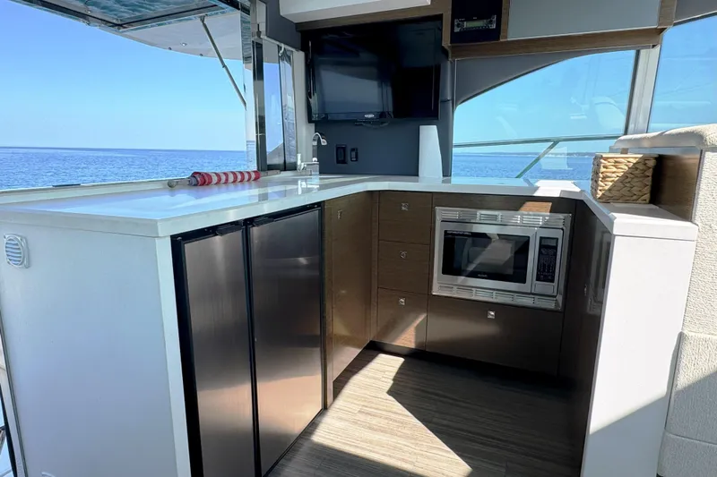  Yacht Photos Pics Luxurious 2017 Cruisers Yachts 45 Cantius interior with modern kitchen and ocean view.