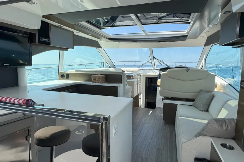  Yacht Photos Pics Luxurious interior of 2017 Cruisers Yachts 45 Cantius with modern seating and panoramic windows.