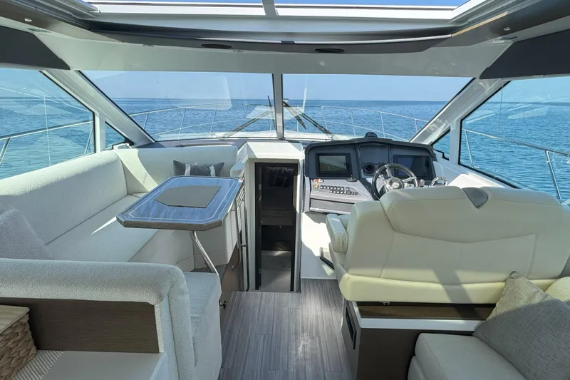  Yacht Photos Pics Interior of 2017 Cruisers Yachts 45 Cantius with helm and seating area.
