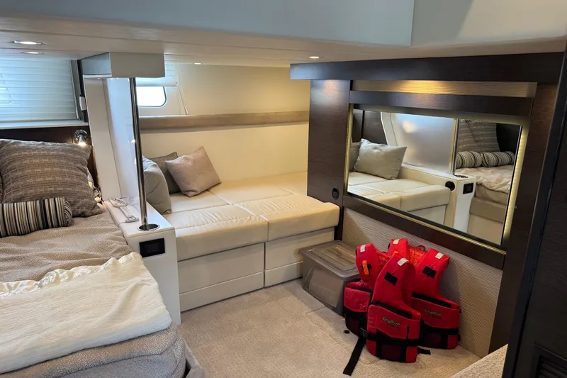  Yacht Photos Pics Luxurious 2017 Cruisers Yachts 45 Cantius cabin interior with cozy seating and life jackets.