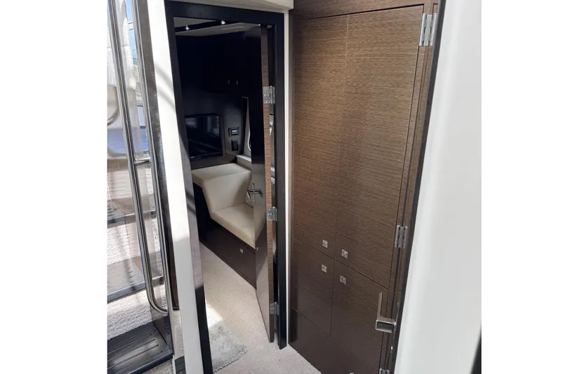  Yacht Photos Pics Interior view of 2017 Cruisers Yachts 45 Cantius, featuring sleek wood paneling and modern design.