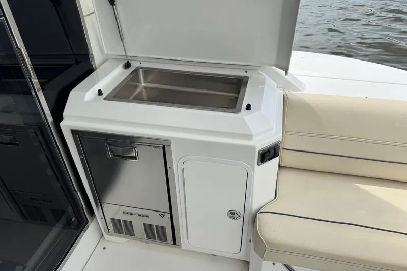  Yacht Photos Pics Outdoor kitchenette on 2017 Cruisers Yachts 45 Cantius with sink and seating.