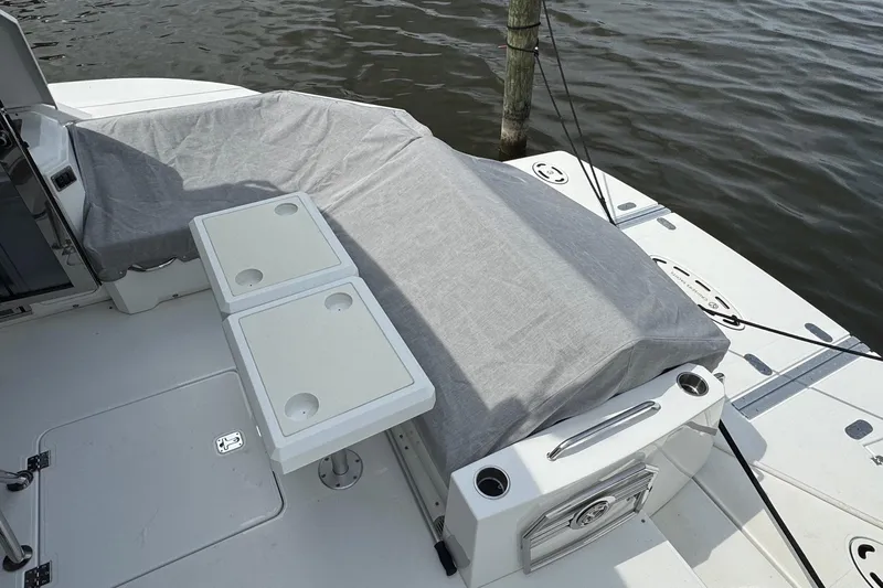  Yacht Photos Pics 2017 Cruisers Yachts 45 Cantius deck with covered seating and table, docked by water.