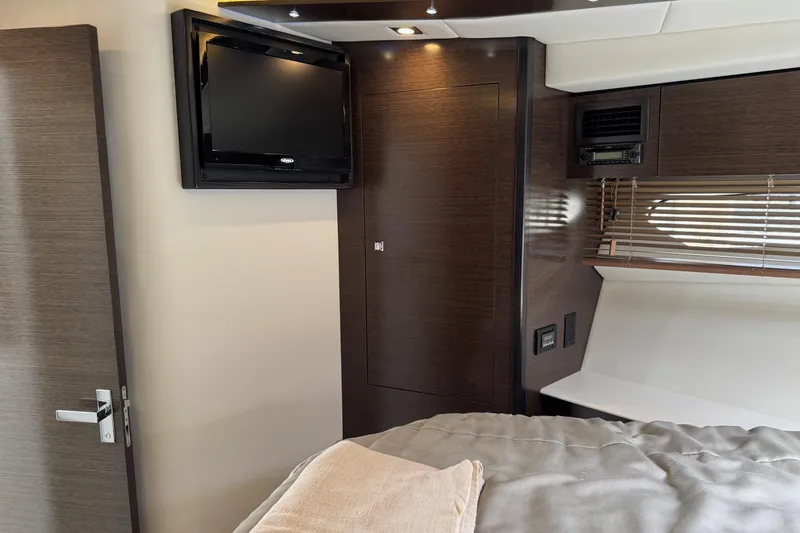  Yacht Photos Pics 2017 Cruisers Yachts 45 Cantius interior with TV, wood paneling, and modern design.