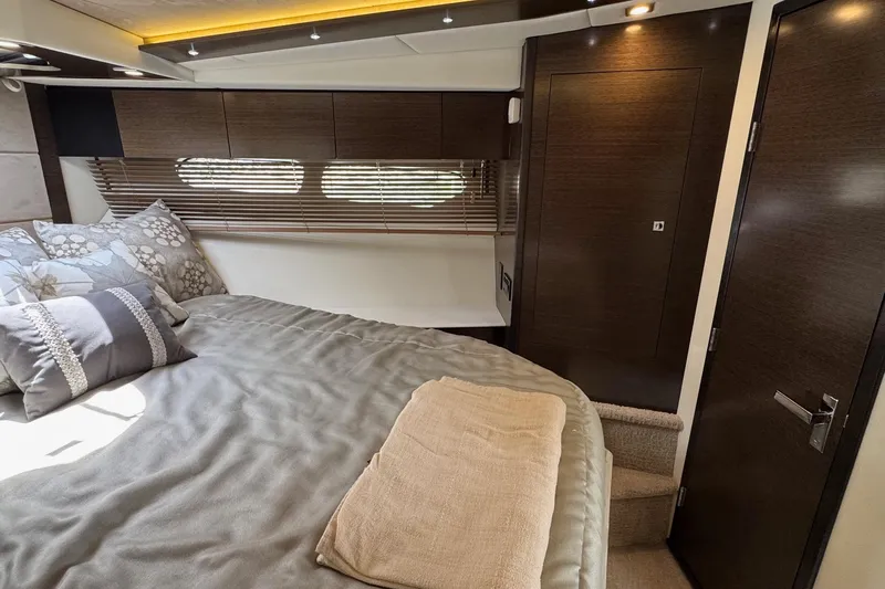  Yacht Photos Pics Luxurious bedroom interior of 2017 Cruisers Yachts 45 Cantius with modern design and cozy bedding.
