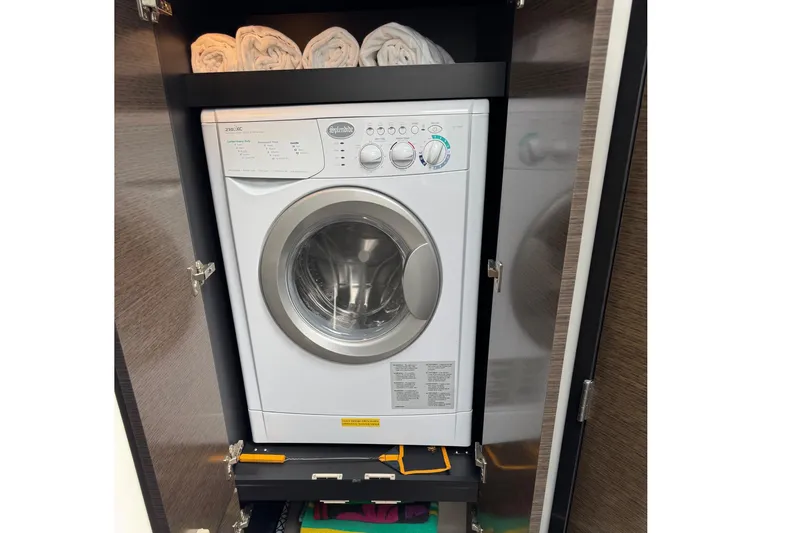  Yacht Photos Pics Washing machine in 2017 Cruisers Yachts 45 Cantius, with towels on shelf above.
