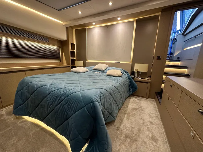  Yacht Photos Pics Luxurious bedroom interior of a 2017 Prestige 680 yacht with modern design and ambient lighting.