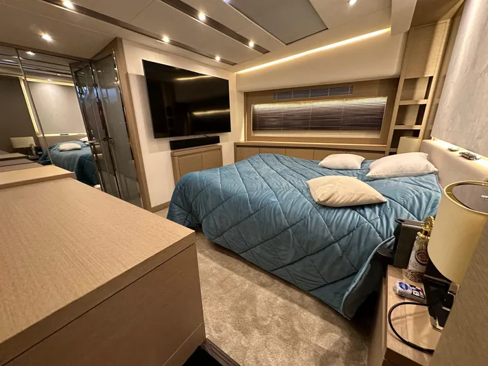 Yacht Photos Pics Luxurious bedroom interior of 2017 Prestige 680 yacht with modern decor and large TV.