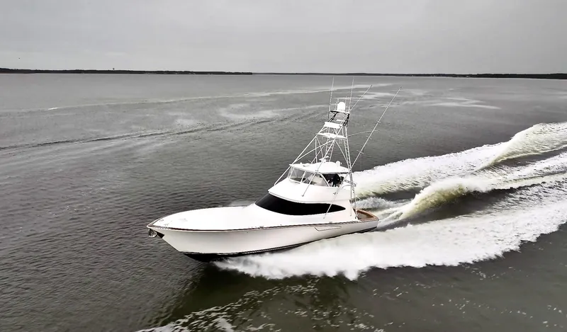 Slow Your Roll Yacht Photos Pics 2019 Viking 68 Convertible yacht cruising swiftly on open water.