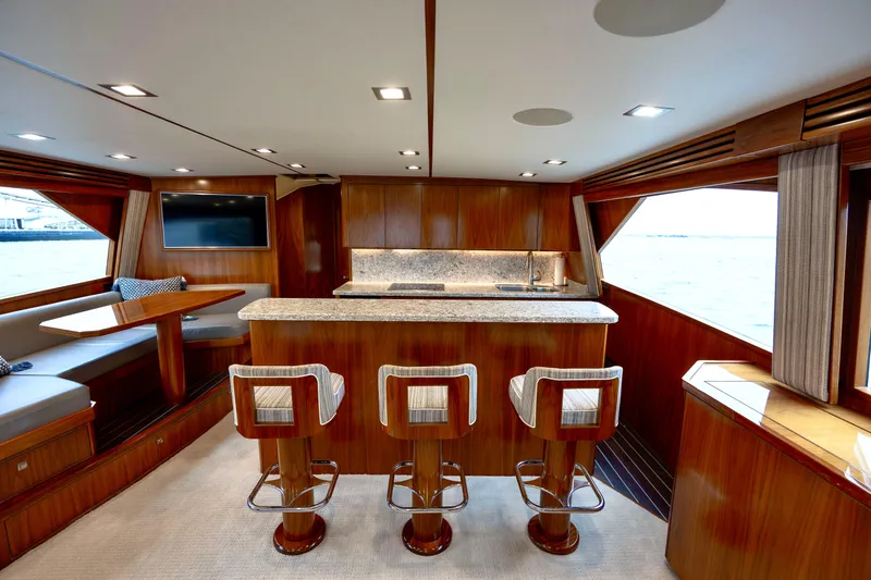 Slow Your Roll Yacht Photos Pics Luxurious interior of 2019 Viking 68 Convertible yacht with bar and seating area.