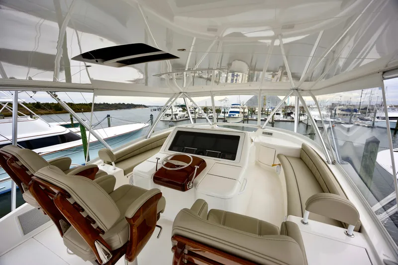 Slow Your Roll Yacht Photos Pics Luxurious interior of 2019 Viking 68 Convertible yacht with plush seating and modern controls.