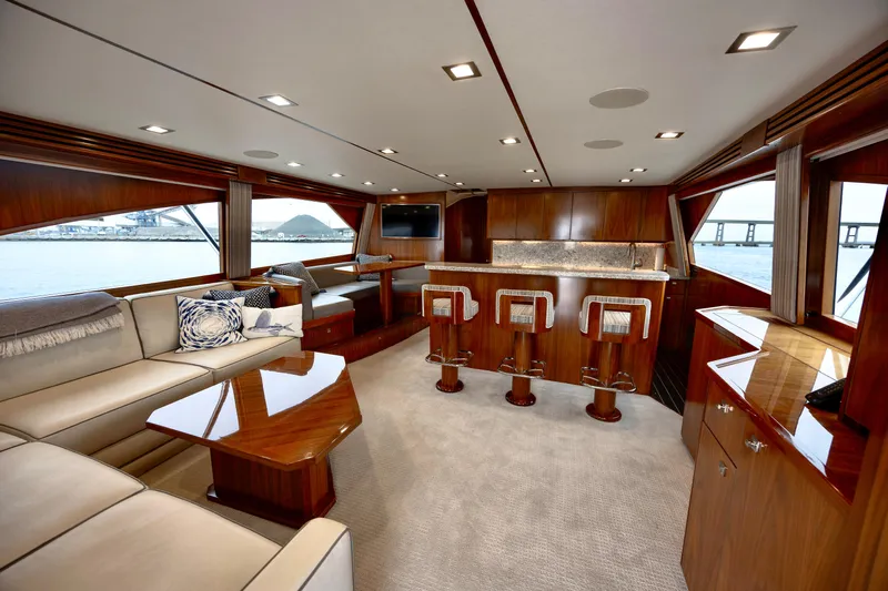 Slow Your Roll Yacht Photos Pics Luxurious interior of 2019 Viking 68 Convertible yacht with elegant wood finishes and seating.