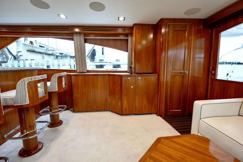Slow Your Roll Yacht Photos Pics Luxurious interior of 2019 Viking 68 Convertible yacht with wooden cabinetry and seating.
