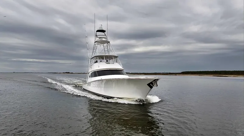 Slow Your Roll Yacht Photos Pics 2019 Viking 68 Convertible yacht cruising on a cloudy day.