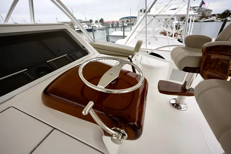 Slow Your Roll Yacht Photos Pics 2019 Viking 68 Convertible yacht helm with polished wood and chrome details.
