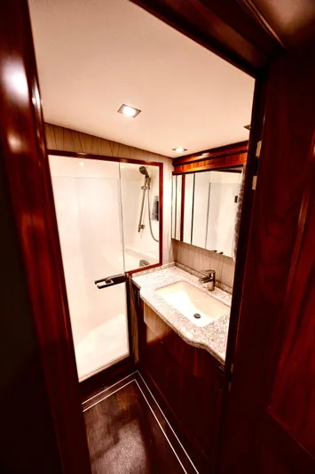 Slow Your Roll Yacht Photos Pics Luxurious bathroom in 2019 Viking 68 Convertible yacht with modern fixtures and wood accents.