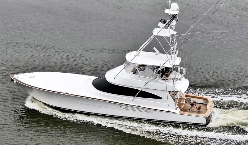 Slow Your Roll Yacht Photos Pics 2019 Viking 68 Convertible yacht cruising on water, side view.