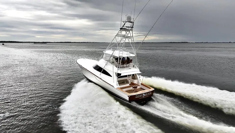 Slow Your Roll Yacht Photos Pics 2019 Viking 68 Convertible yacht cruising on open water under cloudy skies.