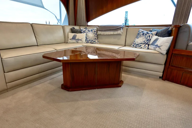 Slow Your Roll Yacht Photos Pics Luxurious interior of 2019 Viking 68 Convertible yacht with elegant seating and wooden table.