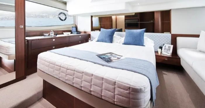  Yacht Photos Pics Luxurious bedroom interior of 2024 Princess F50 yacht with elegant decor and sea view.