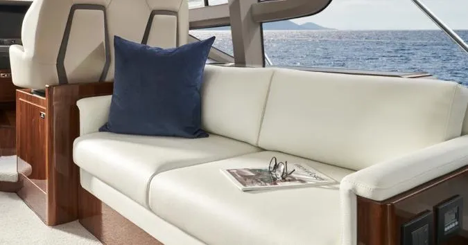  Yacht Photos Pics Luxurious interior of 2024 Princess F50 yacht with white leather seating and ocean view.