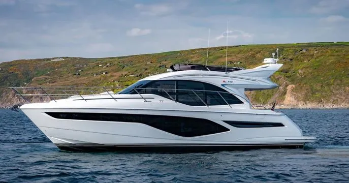  Yacht Photos Pics 2024 Princess F50 yacht cruising on the ocean with scenic coastline backdrop.