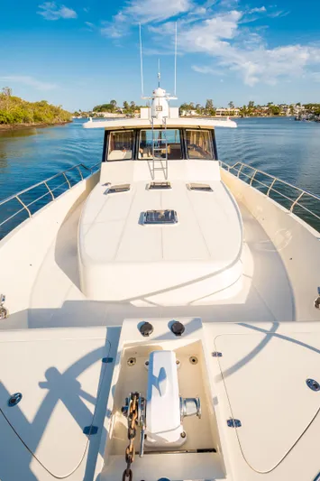  Yacht Photos Pics 2026 Alaska 59 Sedan yacht on serene water with clear blue sky.