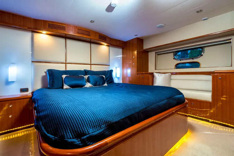  Yacht Photos Pics Luxurious interior of 2026 Alaska 59 Sedan yacht with elegant blue bedding and ambient lighting.