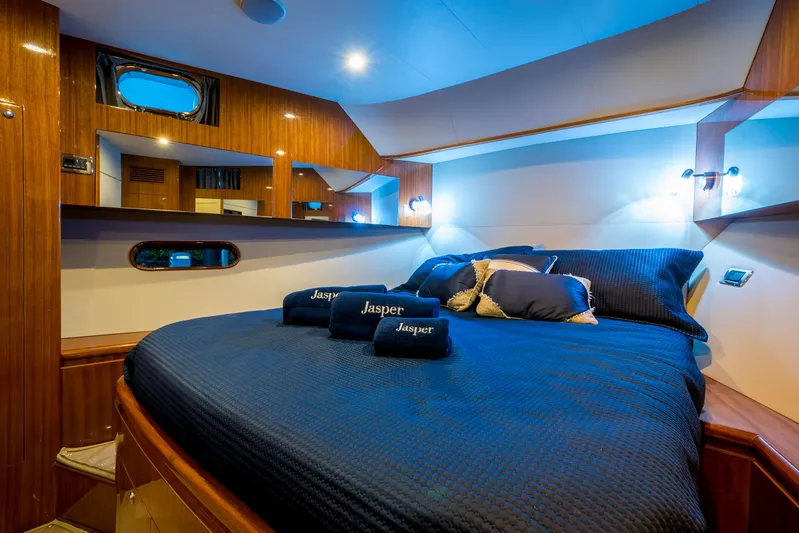  Yacht Photos Pics Luxurious cabin interior of 2026 Alaska 59 Sedan yacht with cozy bedding and elegant wood finish.