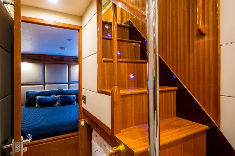  Yacht Photos Pics Luxurious interior of 2026 Alaska 59 Sedan yacht with wooden stairs and cozy bedroom.