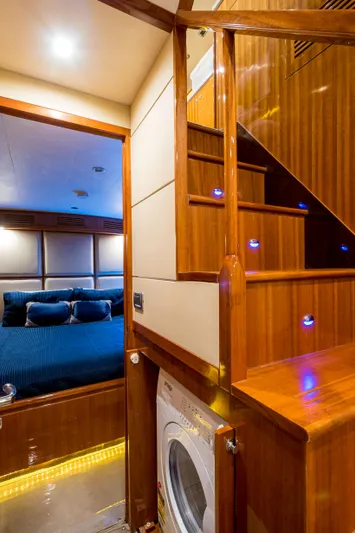  Yacht Photos Pics Luxurious interior of 2026 Alaska 59 Sedan yacht with wooden stairs and cozy bedroom.