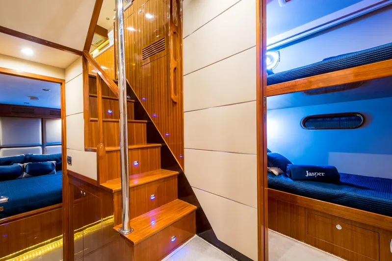  Yacht Photos Pics Luxurious interior of 2026 Alaska 59 Sedan yacht with wooden stairs and cozy bunk beds.