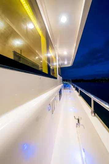  Yacht Photos Pics Side view of 2026 Alaska 59 Sedan yacht with illuminated deck at dusk.