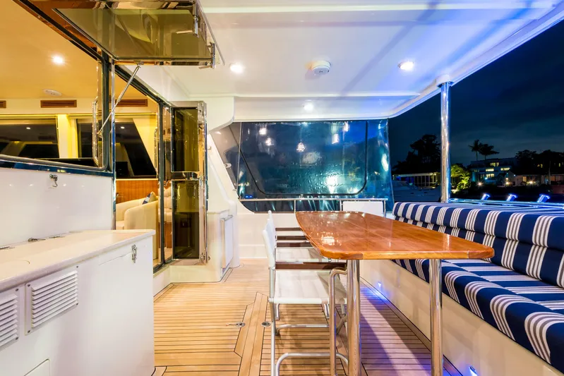  Yacht Photos Pics Luxurious 2026 Alaska 59 Sedan yacht interior with elegant seating and dining area at night.