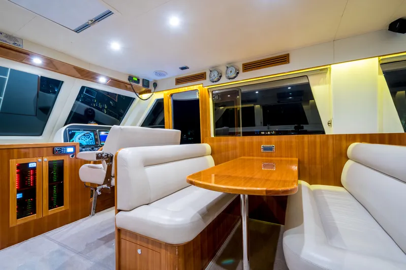  Yacht Photos Pics Luxurious interior of 2026 Alaska 59 Sedan yacht with modern seating and navigation controls.