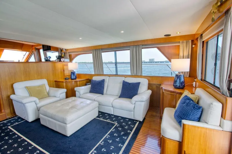 The Cotton Picker Yacht Photos Pics Luxurious interior of 2000 Ocean Alexander 610 Pilothouse yacht with plush seating and ocean view.